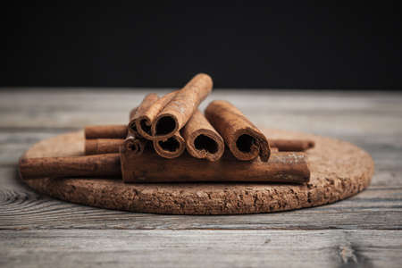 Cinnamon sticks on wooden background. High quality photoの写真素材