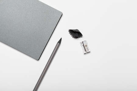 Grey notepad and pencil on working table top viewの写真素材