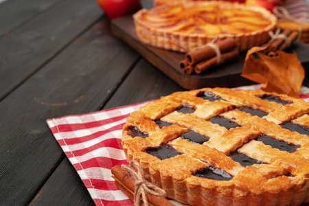 Close up of homemade traditional sweet autumn raspberry tart pie on wooden table