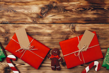 Christmas present and festive gingerbread cookies on wooden backgroundの写真素材