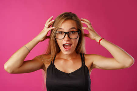 Young beautiful woman suffering from headache with hands on headの写真素材