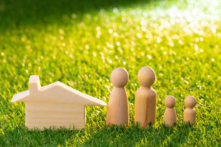 Wooden men figures and toy wooden houseの写真素材