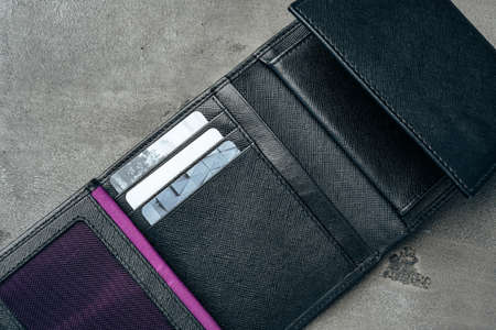 Black leather wallet on grey concrete backgroundの写真素材