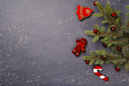 Spruce branches and red Christmas baubles top view