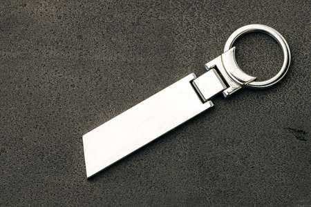 Metal key pendant on dark concrete background