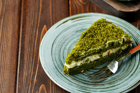 Piece of green spinach cake on plateの写真素材
