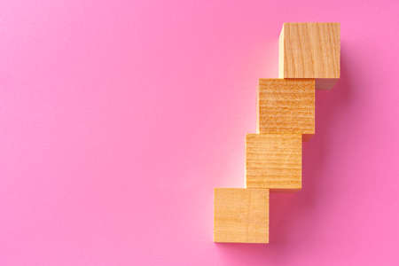 Top view of toy wooden blocks on pinkの写真素材
