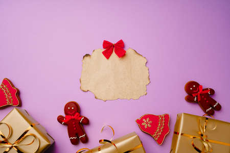 Flatlay composittion with Santa list and wrapped gift boxes on purple background