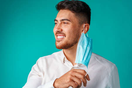 Handsome mixed-race man wearing medical face maskの写真素材