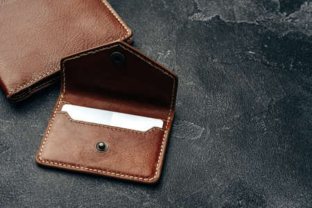 New brown leather wallet on dark background