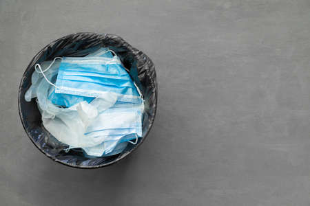 Used infectious masks and medical glove in the trash