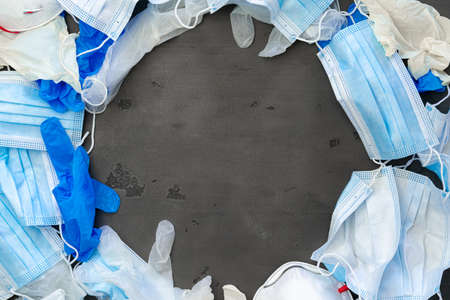Surgical gloves and medical protective mask on a dark background.