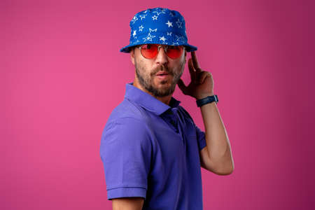 Funny bearded smiley man wearing beach hat and sunglassesの写真素材