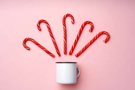 Candy canes on pink background top viewの写真素材