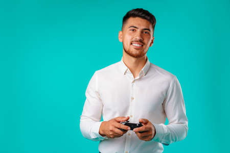 Handsome mixed-race man holding video games joystickの写真素材