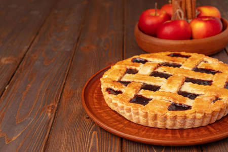Close up of homemade traditional sweet autumn raspberry tart pie on wooden tableの写真素材