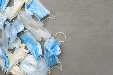Surgical gloves and medical protective mask on a dark background.