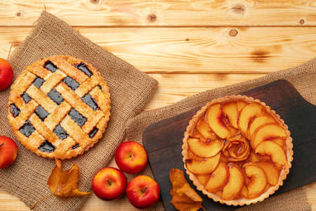 Thanksgiving berry and apple various pies on wooden surface, top viewの写真素材