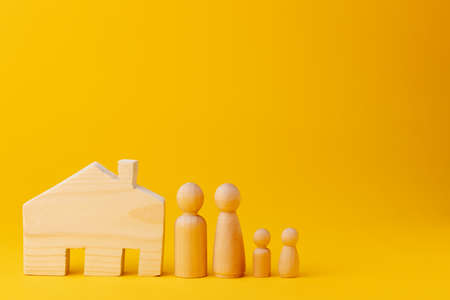 Wooden men figures and toy wooden houseの写真素材