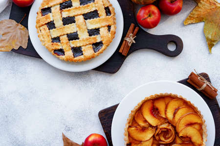 Berry tart pie and orange pumpkin on wooden table
