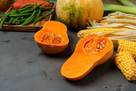 Close up photo of pumpkin on dark cooking table