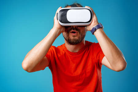 Casual bearded man using virtual reality glasses