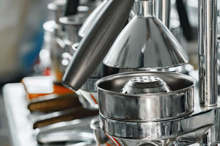 New metal manual juicers in a row on shop shelf