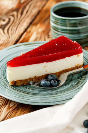 Layered mousse cake piece with berry topping