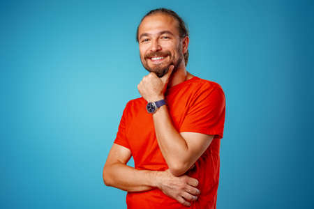 Portrait of a young bearded casual man smiling.