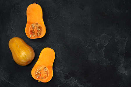 Pile of pumpkins on dark background top view