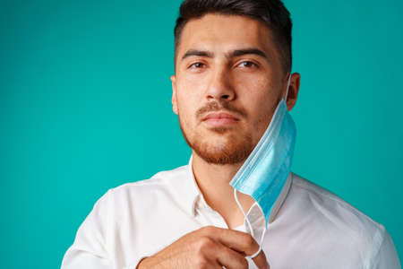 Handsome mixed-race man wearing medical face maskの写真素材