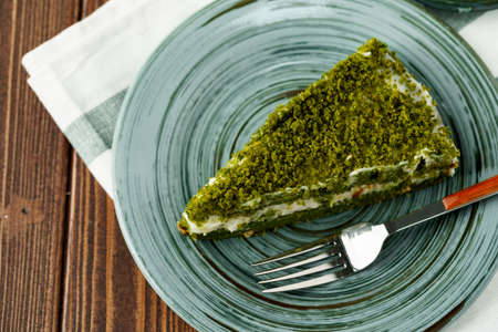 Piece of green spinach cake on plateの写真素材