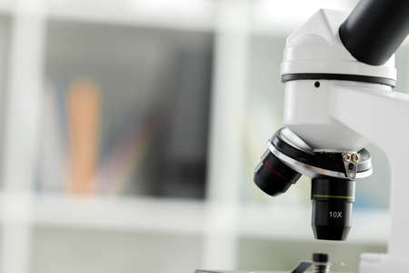 Microscope with metal lens at laboratory close up