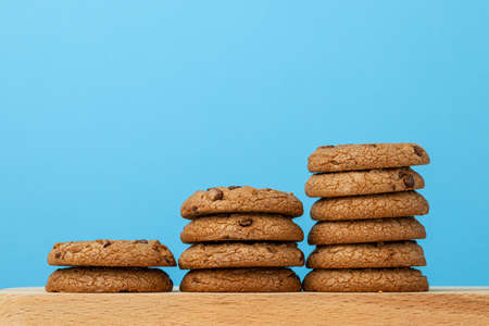 Stack of chocolate chip cookies against blue background