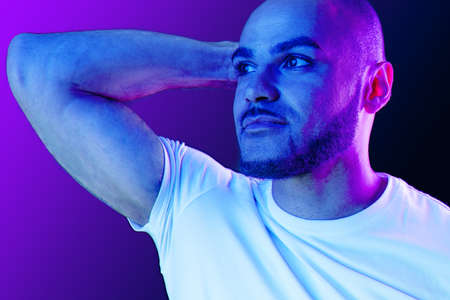 Close up portrait of a black man in purple neon light