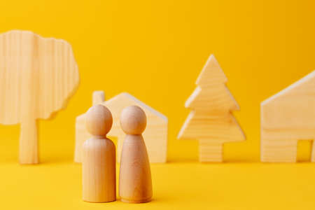 Wooden men figures and toy wooden houseの写真素材