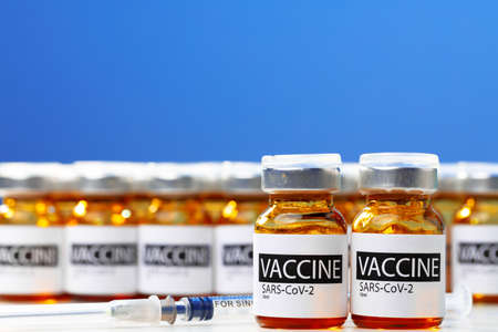 Sars-cov-2 vaccine vial bottles on white table