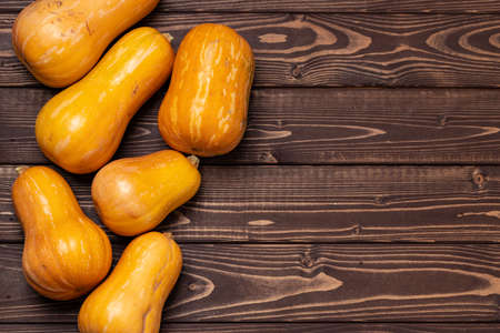 Assortment of small pumpkins on wooden backgroundの写真素材