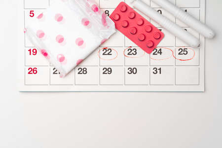 Menstruation calendar with sanitary pads and tampons, pills