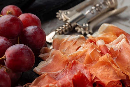 Wooden platter with meat cuts close upの写真素材