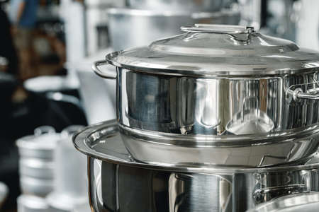 Stacked industrial metal cooking pots on proffesional kitchenの写真素材