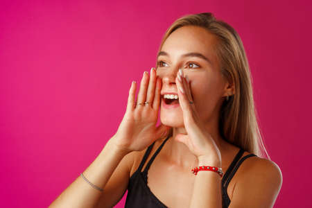 Cute blonde woman screams using her hands as tubeの写真素材