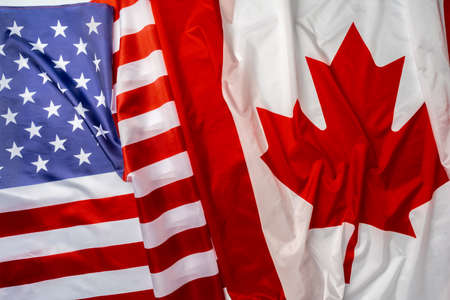 Flags of Canada and USA folded togetherの写真素材
