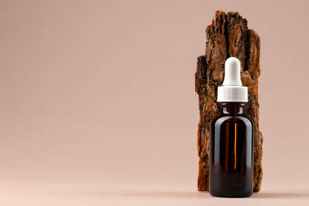 Beauty oil bottle with pipette on beige backgroundの写真素材