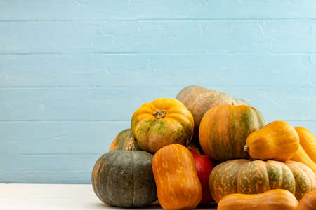 Assortment of small pumpkins on wooden background