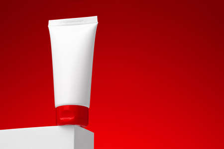 Blank cosmetic skincare container against red backgroundの写真素材
