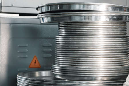 A lot of stacked metal trays in kitchenの写真素材