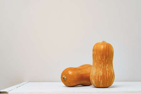 Pumpkins on kitchen table against grey wall
