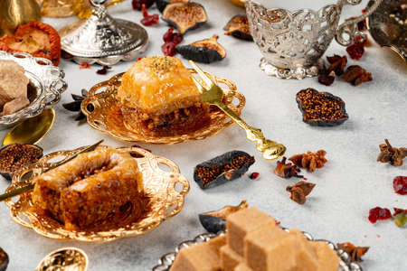 Piece of Turkish baklava in golden arabic plateの写真素材