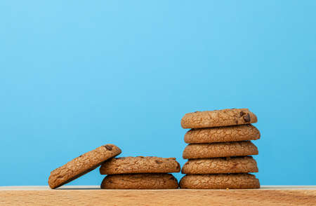 Stack of chocolate chip cookies against blue backgroundの写真素材